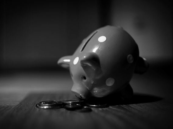Piggy bank bent forward change money coins (Andre Taissin/Unsplash, modified by CoinDesk)