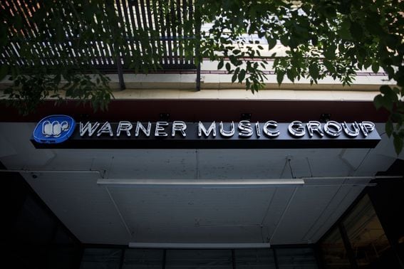 Warner Music Group Inc. signage is displayed outside the company's headquarters in the Arts District neighborhood of Los Angeles, California, U.S., on Wednesday, June 3, 2020. Warner Music Group's shareholders have raised $1.93 billion in an upsized initial public offering that ranks as one of the biggest U.S. listing this year. Photographer: Patrick T. Fallon/Bloomberg via Getty Images