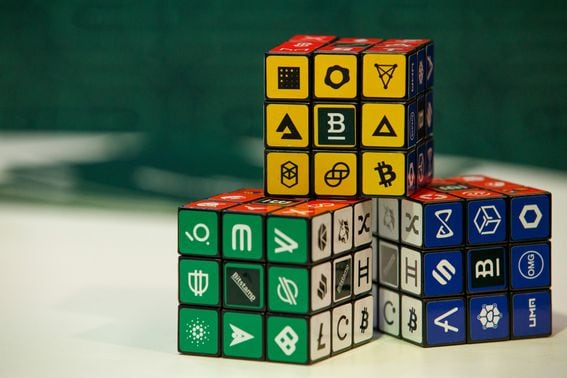 Puzzle cubes displaying logos of different cryptocurrencies and exchanges at the CryptoCompare Digital Asset Summit at Old Billingsgate in London, U.K., on Wednesday, March 30, 2022. Bitcoin and other cryptocurrencies had been, up until the last few weeks, mired in a similar downtrend as other riskier assets, like U.S. stocks. Photographer: Luke MacGregor/Bloomberg via Getty Images