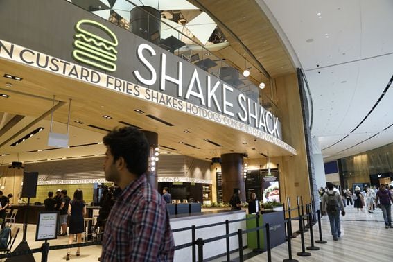People walk past a Shake Shack Inc. restaurant during a media tour of the Jewel Changi Airport in Singapore, on Thursday, April 11, 2019. The Jewel is a new mega-attraction at Singapore's Changi Airport and will open its doors to the public on April 17. Photographer: Wei Leng Tay/Bloomberg via Getty Images