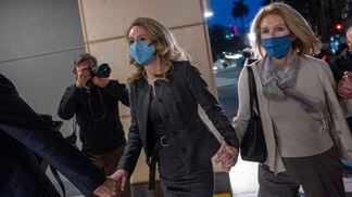 Elizabeth Holmes, founder of Theranos, left, departs from federal court after her conviction on fraud charges. (David Paul Morris/Bloomberg via Getty Images)