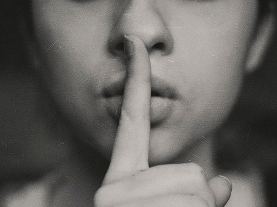 CDCROP: Hush shush finger to lips quiet sign (Kristina Flour/Unsplash)