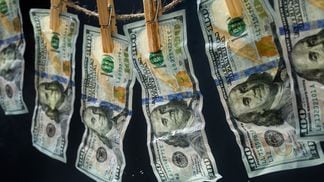 Laundered dollars hanging on a rope with clothespins (Alexander Sava/Getty Images)
