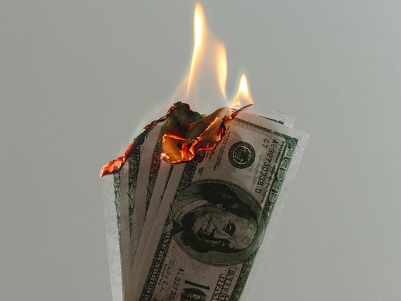 Money to burn cash on fire (Jp Valery/Unsplash)
