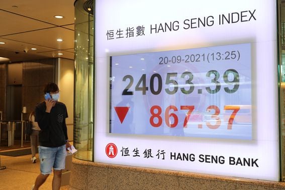 A ticker shows the Hang Seng Index sinking on Sept. 20, 2021, amidst anxiety about major Chinese developer Evergrande. China's equity troubles run much deeper than one company. (Bloomberg viaGetty)