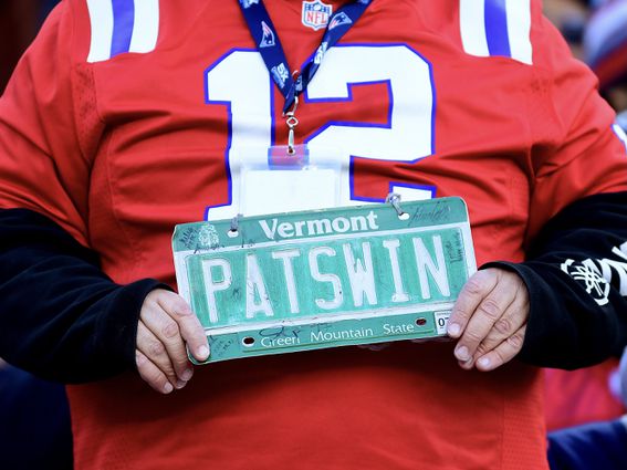 A fan holds a sign for the New England Patriots during a game in Foxboro, Mass.