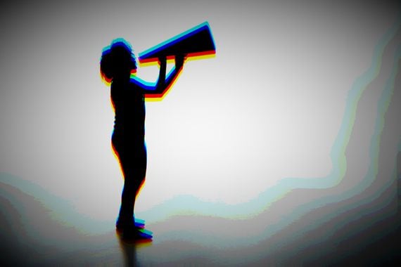 Silhouette of a female holding a analog megaphone.