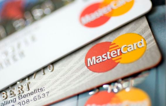 Mastercard logos appear on credit cards arranged for a photo