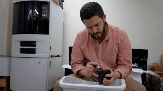 Cody Wilson with a 3D-printed Liberator pistol, in a scene from "Death Atheltic." (Jessica Solce)