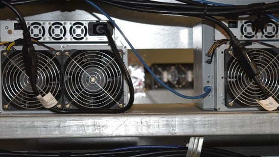A photo of four mining rigs
