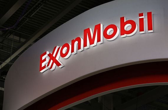 A logo sits illuminated outside the Exxon Mobil Corp. corporate pavilion during the 21st World Petroleum Congress in Moscow, Russia, on Monday, June 16, 2014. Work between Texas-based Exxon, the world's largest oil company by market value, and state-run Rosneft on Sakhalin Island in Russias Far East provides a template for further exploration, especially in the Arctic's Kara Sea, Exxon Mobil Corp. Chief Executive Officer Rex Tillerson said at the World Petroleum Congress in Moscow today. Photographer: Andrey Rudakov/Bloomberg via Getty Images