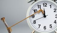 Time on clock stop by nail delay concept. (Dimj/Shutterstock)