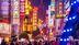 Crowds walk below neon signs on Nanjing Road, Shanghai, China. (Getty Images)