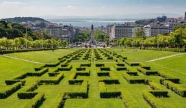 Stunning view of Lisbon from a manicured green lawn in foreground to the sea on the horizon (Sally Wilson/Pixabay)