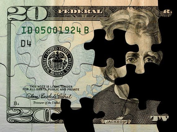 A U.S. $20 currency jigsaw puzzle with pieces missing, part of a solution for home finances or solving financial problems. (Getty Images)