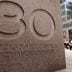 A pedestrian passes a sign outside the building which houses the Chicago Mercantile Exchange (Scott Olson/Getty Images)