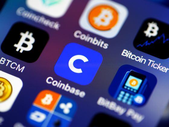 PARIS, FRANCE - FEBRUARY 26: In this photo illustration, the Coinbase cryptocurrency exchange logo (C) is seen on the screen of an iPhone on February 26, 2021 in Paris, France. Cryptocurrency trading platform Coinbase has filed for registration with the SEC on Thursday for an IPO via direct listing on the Nasdaq and will likely be the largest IPO of the year. Coinbase reported $ 1.28 billion in revenue in 2020 (+ 140% year on year), for net profit of $ 320 million. (Photo illustration by Chesnot/Getty Images)
