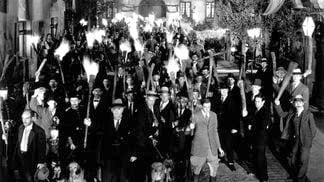 An angry mob holding torches in a still from the film, 'Frankenstein,' directed by James Whale, 1931.