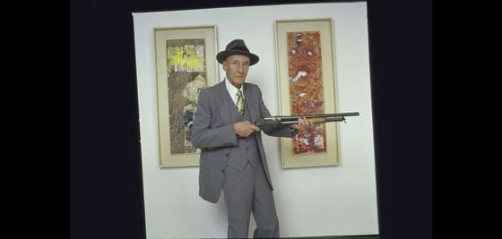 William Burroughs, popularizer of the "cut-up" literary technique. Here he poses with his "shotgun paintings," another artistic exploration of chance operations. (Mario Ruiz/Getty Images)