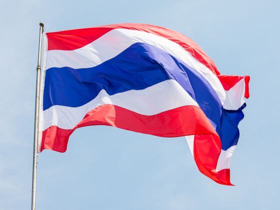 close up of a Thailand flag waving with blue sky in background
