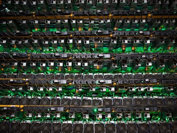 Cryptocurrency mining rigs sit on racks. (James MacDonald/Bloomberg/Getty Images)