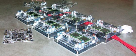  ASIC PCBs (bottom left, background) vs old FPGAs (center)