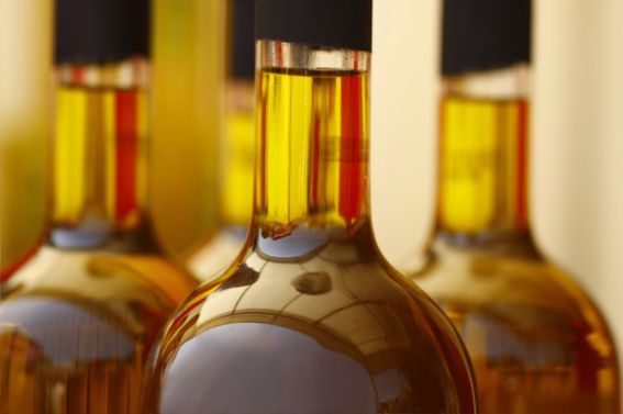 tops-of-glass-bottles-filled-with-brown-liquid