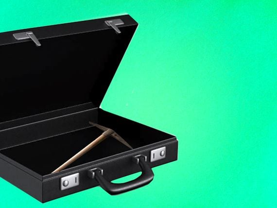 A pickaxe inside a briefcase, symbolizing the entry of traditional businesses into cryptocurrency mining.