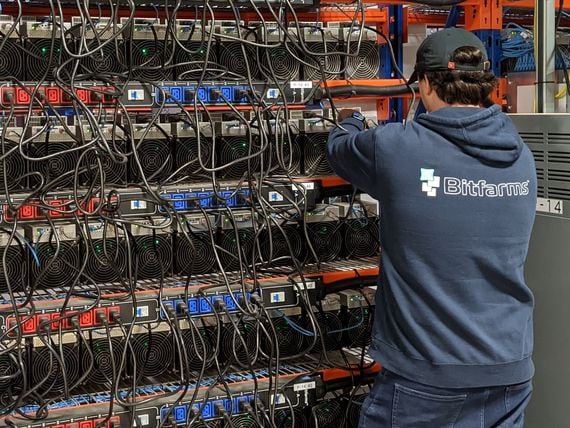 A Bitfarms employee inspects bitcoin mining hardware. (Aoyon Ashraf/CoinDesk)