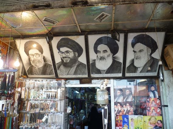 Images of Hassan Nasrallah and Sayyid Ruhollah Musavi Khomeini adorn the walls of a Syrian market. (Leif Stenberg/Shutterstock)