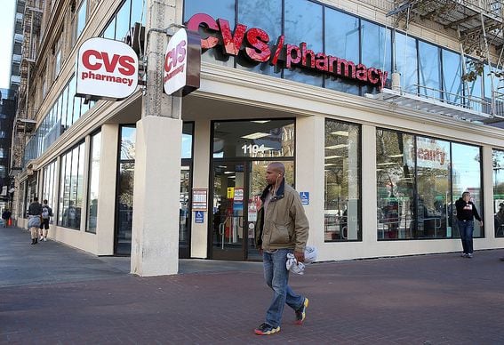 SAN FRANCISCO, CA - NOVEMBER 05:  Pedestrians walk by a CVS store on November 5, 2013 in San Francisco, California.  CVS Caremark reported a 25 percent surge in third-quarter earnings with profits of $1.25 billion, or $1.02 per share, compared to $1.01 billion, or 79 cents a share one year ago.  (Photo by Justin Sullivan/Getty Images)