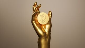 golden hand holding a bitcoin (Getty Images)