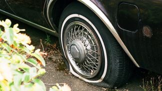 Flat tire on a car deflated stuck (Sebastian Huxley/Unsplash)