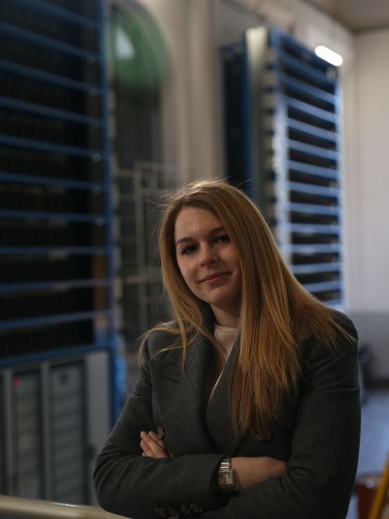 Francesca Failoni, 23, co-founder and chief financial officer at Alps Blockchain, standing in front of the bitcoin mining farm in Valstagna's hydropower plant (Sandali Handagama/CoinDesk)