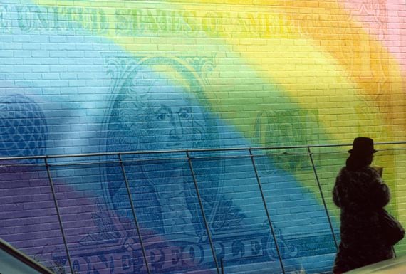 View of an unspecified wall decorated with an oversized, rainbow-colored dollar bill in Manhattan's Lower East Side neighborhood, New York, New York, February 1988. (Photo by Susan Wood/Getty Images)