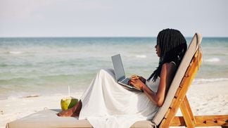 Crypto freelancer on beach (Getty)