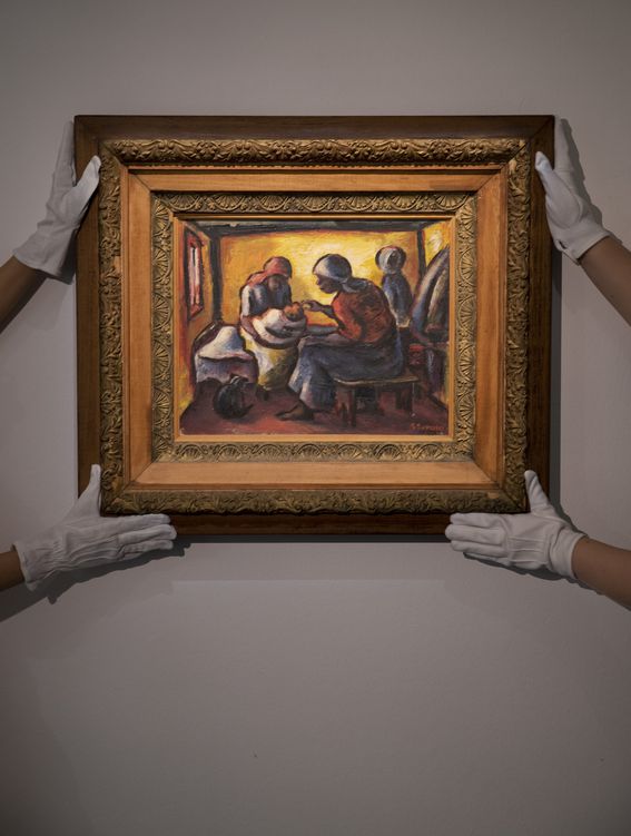 Workers at Sotheby's prepare for the auction of "The Visitor" by South African artist Gerard Sekoto. (John Phillips/Getty Images)