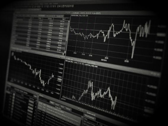 A black and white image of a monitor showing trades, representing crypto use in dark web markets.