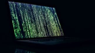 CDCROP: Laptop code matrix green darkness (Unsplash)