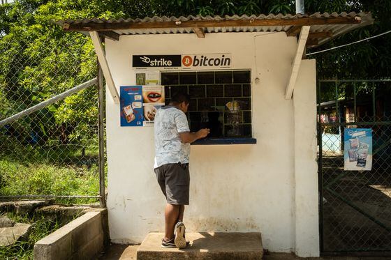 A person purchases a bottle of Coca-Cola from a shop that accepts Bitcoin in El Zonte, El Salvador, on Monday, June 14, 2021.