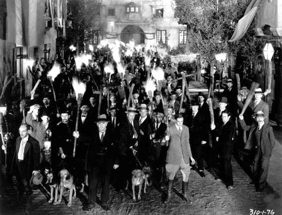 An angry mob holding torches in a still from the film, 'Frankenstein,' directed by James Whale, 1931.