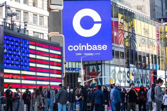 Monitors display Coinbase signage during the company's public listing on the Nasdaq stock exchange in April 2021.