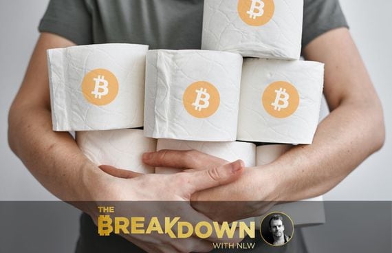 Photo of person hoarding toilet paper with bitcoin logo, representing the bitcoin shortage due to paypal and the cash app.