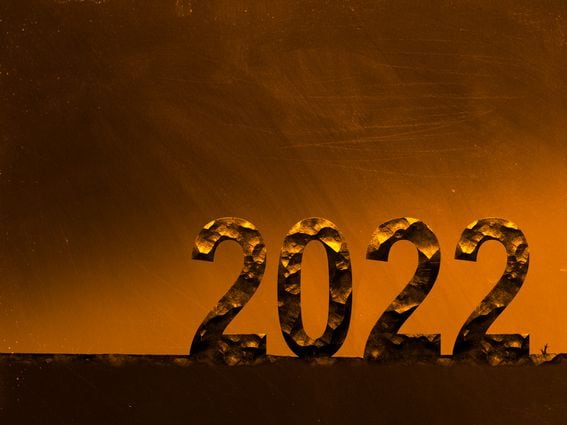 Bitcoin mining in 2022 numbers cared in rock on orange background