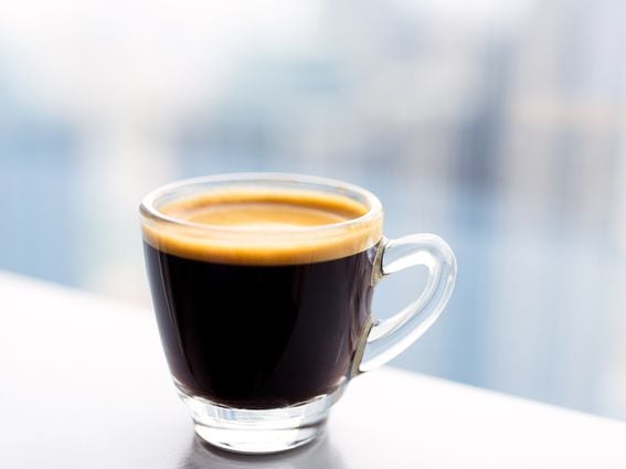 Tiny glass cup of espresso coffee