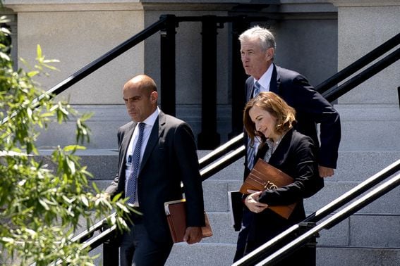 Jerome Powell, chairman of the U.S. Federal Reserve, top, walks to the West Wing of the White House in Washington on June 21. He's accompanied by Rostin Behnam, acting chairman of the Commodity Futures Trading Commission, left, and Jelena McWilliams, chairman of the Federal Deposit Insurance Corporation. (Stefani Reynolds/Bloomberg via Getty Images)